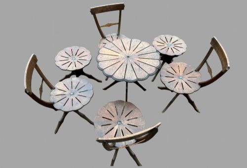fig 1. A seven-piece dark carved oak parlour suite comprising a central round table, five chairs, and one stool with radiating petal design tops and curved trestle legs.