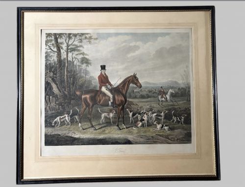 fig 1. A Regency hand-coloured aquatint print depicting a horse rider in hunting attire with foxhounds in an open rural landscape.