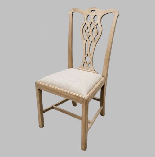 fig 2. A set of eight mid-19th century bleached mahogany dining chairs featuring pierced fretwork splats and neutral fabric upholstered seats.