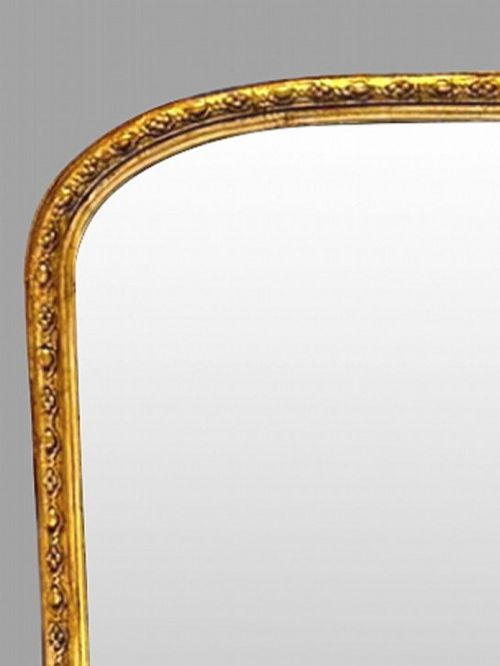fig 1. A large nineteenth-century giltwood pier mirror with an arched upper frame and beaded moulding detail.