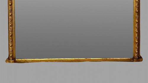 fig 2. A large nineteenth-century giltwood pier mirror with an arched upper frame and beaded moulding detail.