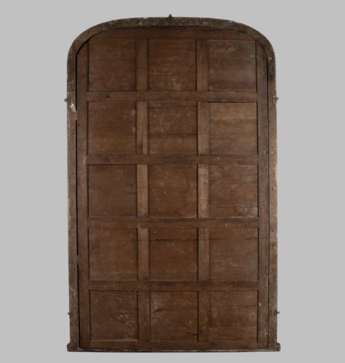 fig 3. A large nineteenth-century giltwood pier mirror with an arched upper frame and beaded moulding detail.