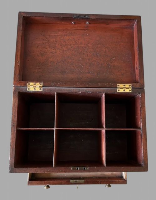 fig 2. A Georgian mahogany wine cellarette featuring a hinged lid with a top brass handle, keyhole, lower drawer, and four turned legs.