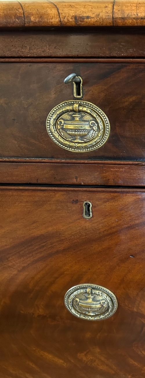 A 19th-century flame mahogany sideboard featuring two upper drawers, two cabinet doors, reeded pilasters, oval brass handles, a low gallery back, and carved paw feet. View VII