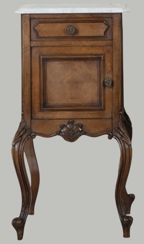 fig 1. A pair of French walnut bedside cabinets featuring white marble tops, single drawers over cupboard doors, carved aprons, and slender cabriole legs.