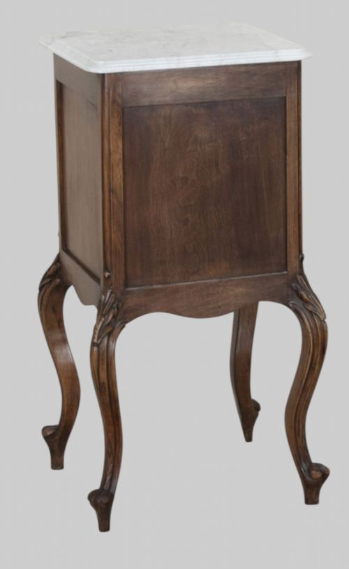 fig 2. A pair of French walnut bedside cabinets featuring white marble tops, single drawers over cupboard doors, carved aprons, and slender cabriole legs.