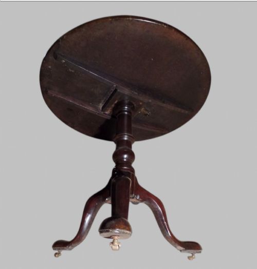 fig 1. A Georgian mahogany tilt-top occasional table featuring a circular surface supported by a turned pedestal stem and tripod cabriole legs.