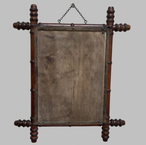 fig 1. An antique turned wood wall mirror styled with a faux bamboo frame finished in a warm brown stain.