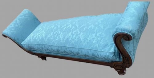 fig 1. A 19th-century French lit bateau daybed upholstered in light blue damask fabric with outward-scrolled ends and dark turned timber feet.