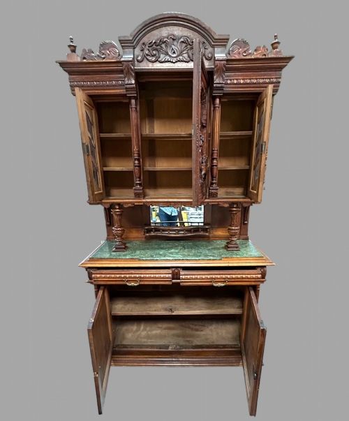 fig 1. A late 19th-century French Provincial walnut dresser featuring hand-carved relief panels, glazed side cabinets, turned support columns, and a green marble insert surface.