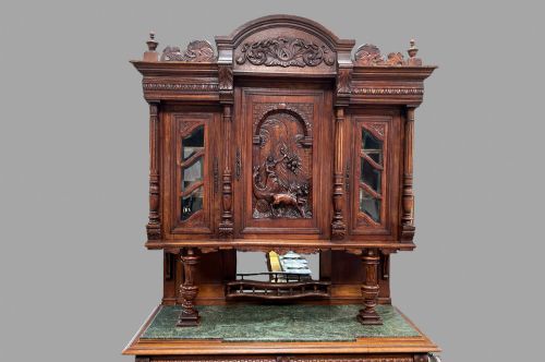 fig 2. A late 19th-century French Provincial walnut dresser featuring hand-carved relief panels, glazed side cabinets, turned support columns, and a green marble insert surface.