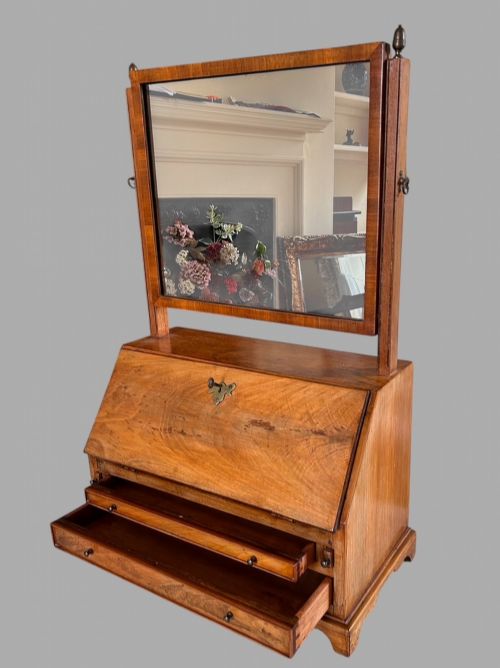 fig 2. An Edwardian satinwood tabletop bureau featuring a slant-front writing slope over small drawers, topped with a rectangular swivel dressing mirror.