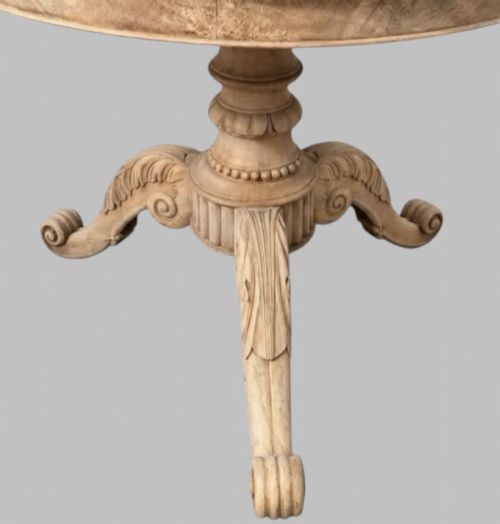 fig 2. A circular antique French gueridon table featuring a dark grey mottled marble top supported by a carved bleached walnut pedestal and tripod scrolled legs.