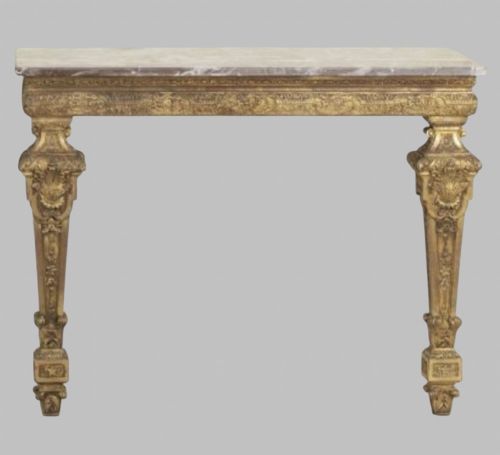 fig 1. A pair of 19th-century Italian giltwood console tables featuring carved tapered legs and fitted marble tops.