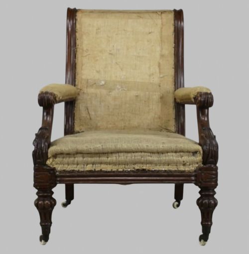 fig 1. Side profile of a William IV carved oak armchair with upholstered seat, scrolled arms, turned front legs, and castors.