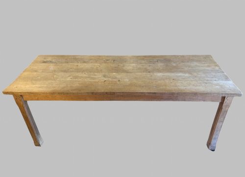 fig 1. A 19th-century rectangular elm farmhouse table featuring a multi-plank top, straight aprons, four square tapering legs, and small metal castors.