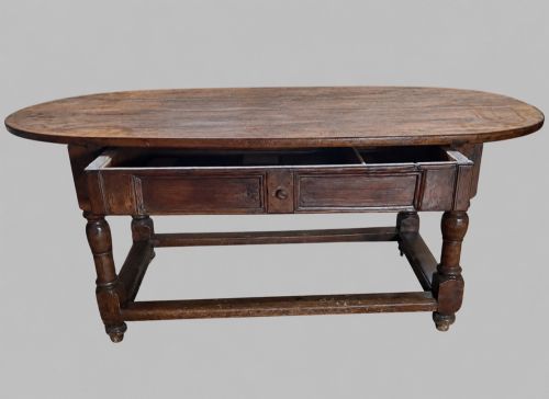 fig 3. An antique Swedish provincial pine farmhouse table featuring an oval plank top, frieze with drawer moulding, turned baluster legs, and a low rectangular box stretcher.