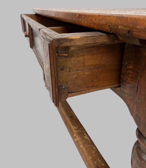 fig 4. An antique Swedish provincial pine farmhouse table featuring an oval plank top, frieze with drawer moulding, turned baluster legs, and a low rectangular box stretcher.