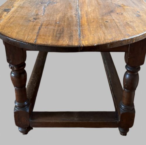 fig 5. An antique Swedish provincial pine farmhouse table featuring an oval plank top, frieze with drawer moulding, turned baluster legs, and a low rectangular box stretcher.