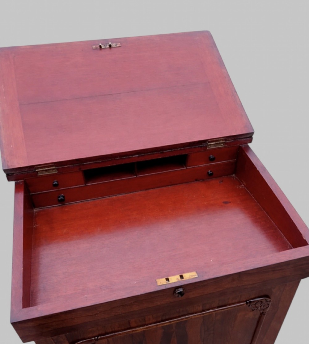 A Victorian rosewood Davenport desk featuring a slanted leather-tooled writing surface, side-mounted drawers, and turned feet. View IV