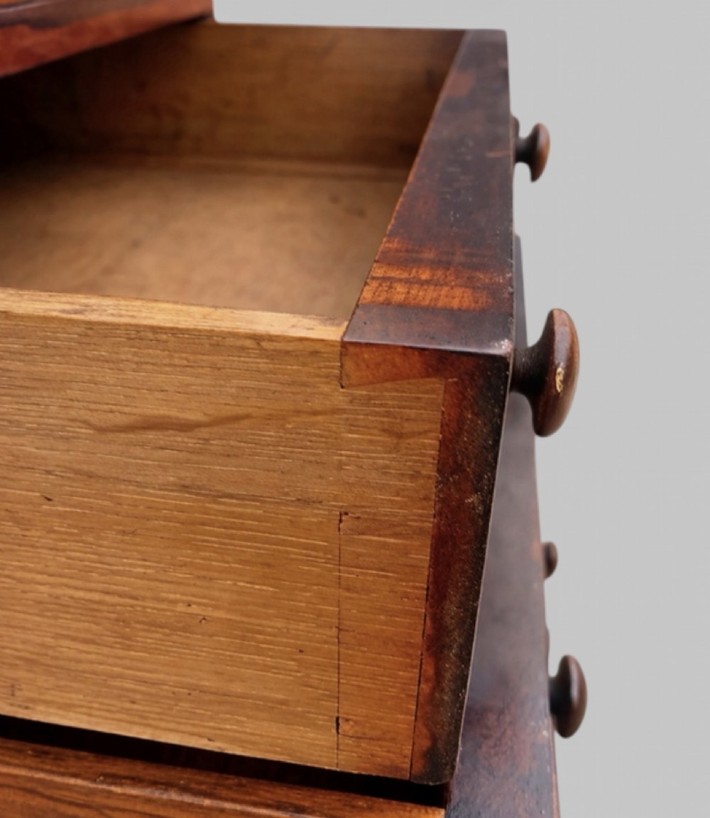 A Victorian rosewood Davenport desk featuring a slanted leather-tooled writing surface, side-mounted drawers, and turned feet. View VI