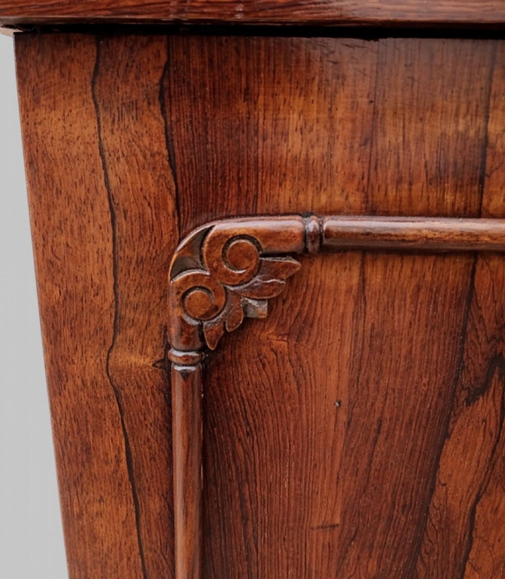 A Victorian rosewood Davenport desk featuring a slanted leather-tooled writing surface, side-mounted drawers, and turned feet. View IX