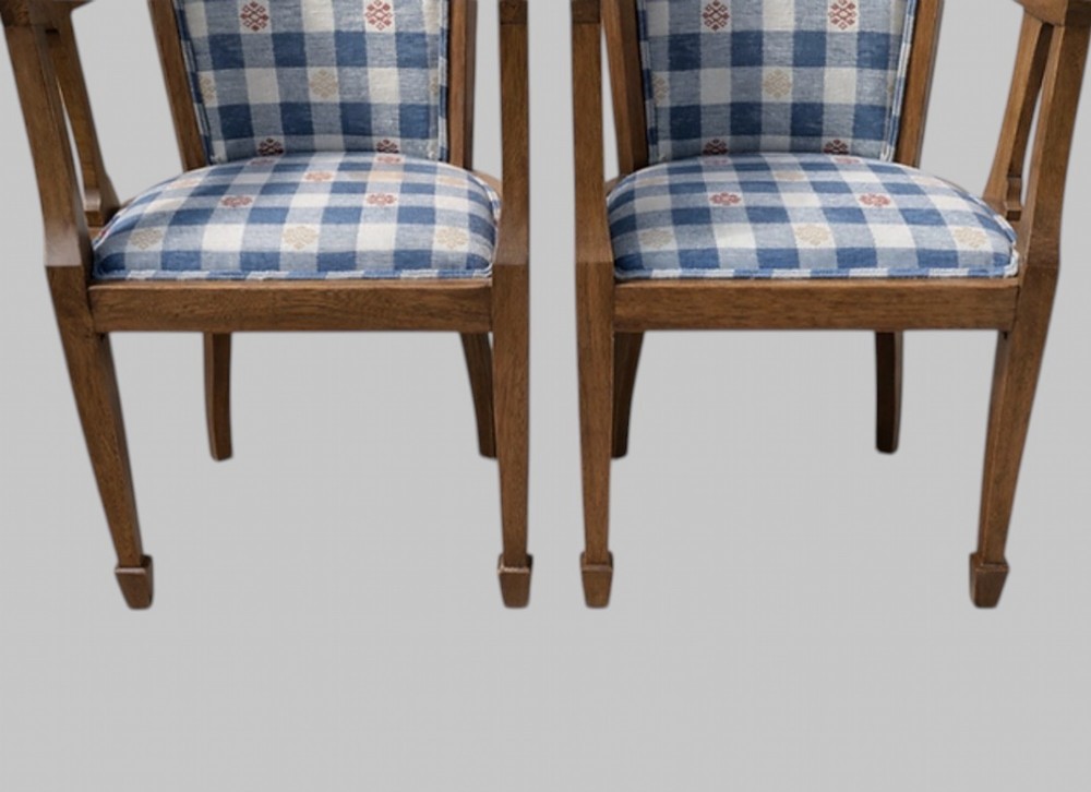 A pair of Arts and Crafts oak tub armchairs with curved wooden frames and blue and white checked fabric upholstery. View IV