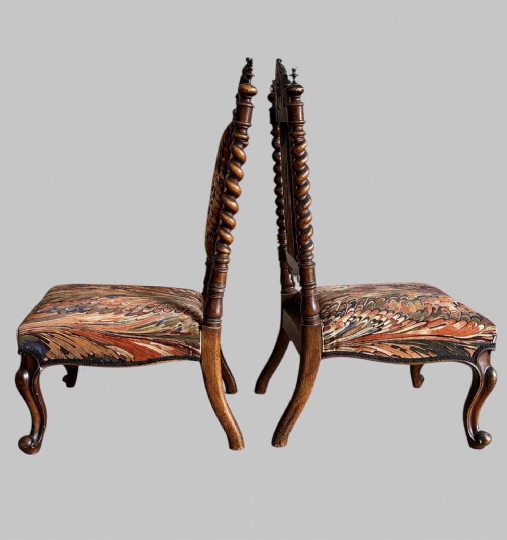 A pair of 19th-century carved walnut hall chairs featuring tall barley twist uprights, ornate cresting, cabriole front legs, and patterned upholstery. View III