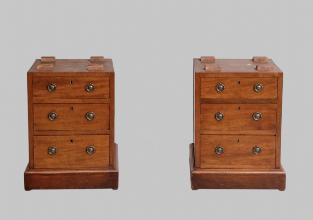 A late Victorian mahogany pedestal desk featuring an inset red leather writing surface, nine drawers with round brass pulls, and two plinth bases. View V