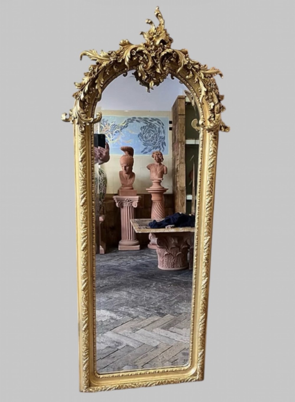 A pair of tall arched giltwood mirrors featuring detailed acanthus leaf cresting and moulded gold frames. View II