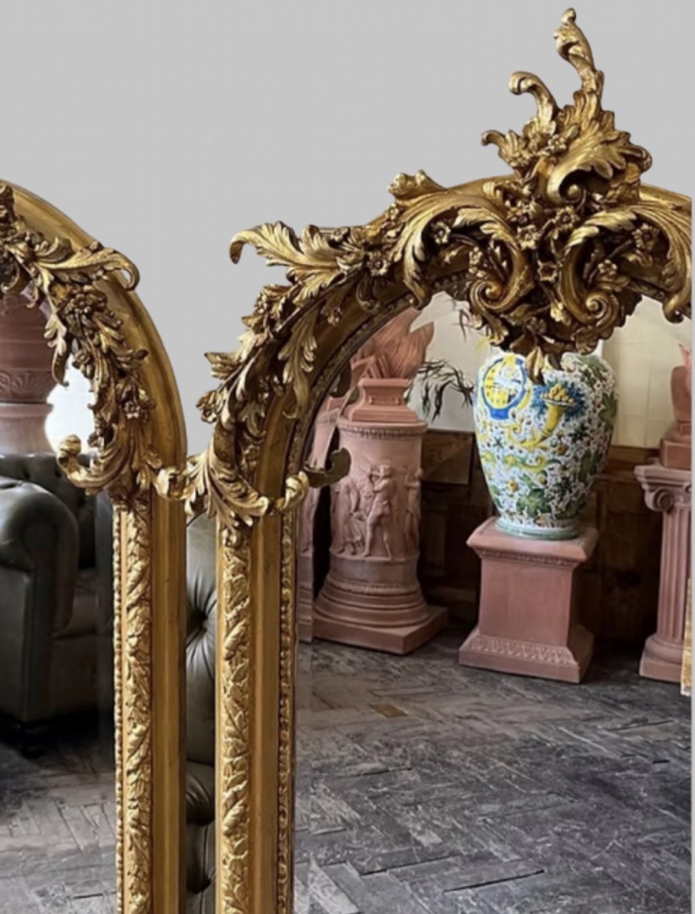 A pair of tall arched giltwood mirrors featuring detailed acanthus leaf cresting and moulded gold frames. View IV
