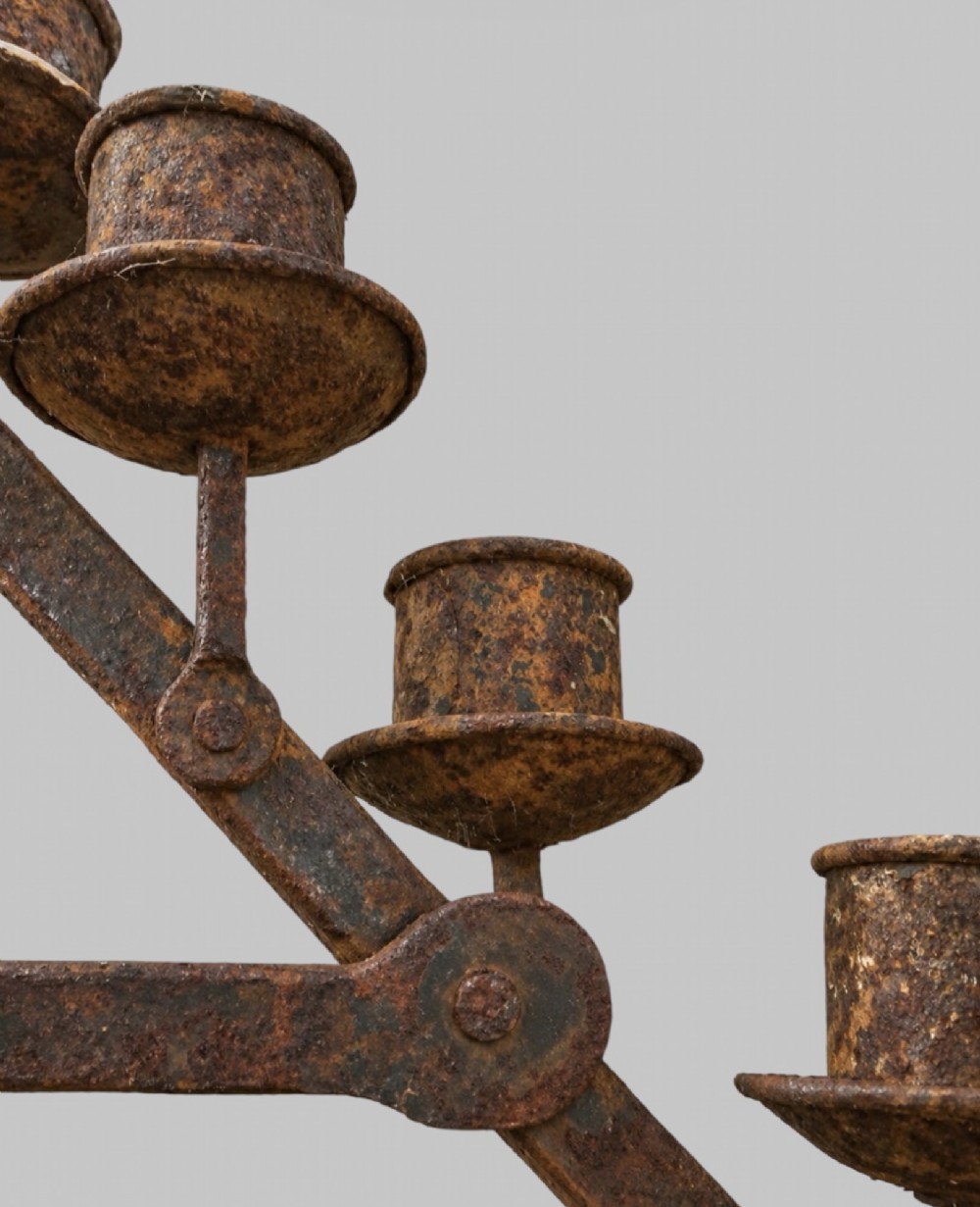 A tall dark wrought iron floor candelabrum featuring a triangular frame with fifteen candle sockets set upon a twisted central stem and tripod base. View V