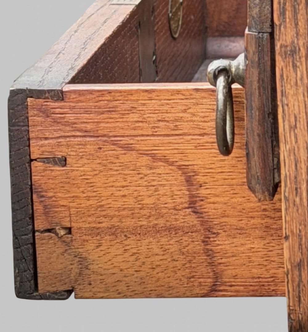Victorian carved oak writing desk featuring a leather inset surface, two raised drawer cabinets on the top, two carved frieze drawers with brass drop handles, turned legs, and stretchers. View VIII