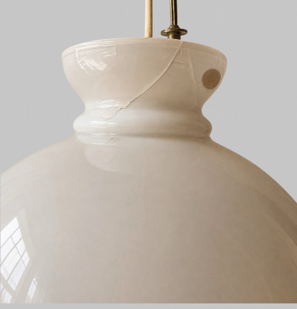 A late Victorian brass hanging lamp featuring a white opaline glass shade, decorative rams head side scrolls, and a central burner unit. View VII