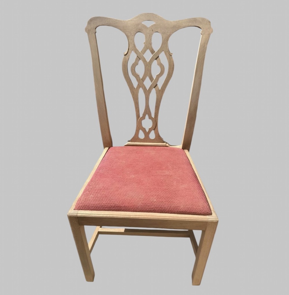 A set of eight bleached mahogany Georgian dining chairs featuring pierced fretwork back splats, straight square legs, and red fabric upholstered seats. View II