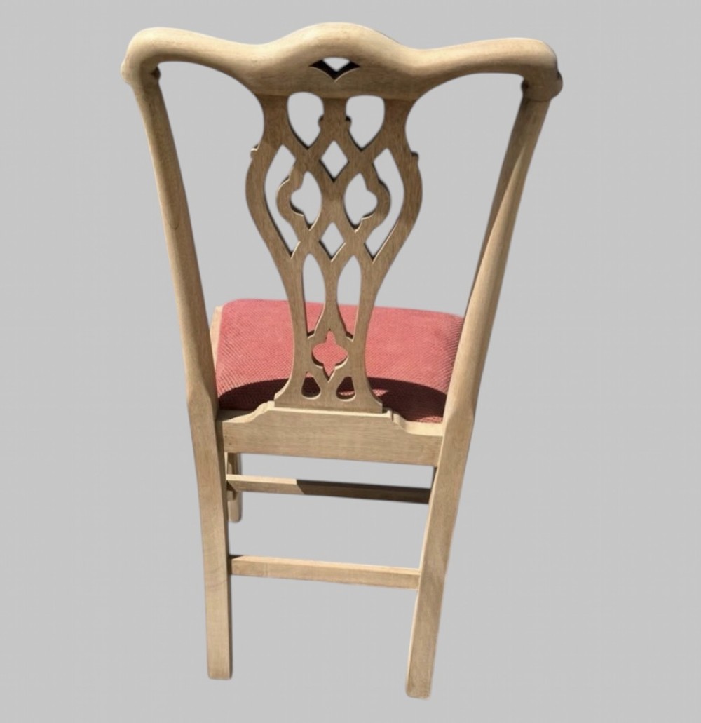 A set of eight bleached mahogany Georgian dining chairs featuring pierced fretwork back splats, straight square legs, and red fabric upholstered seats. View III