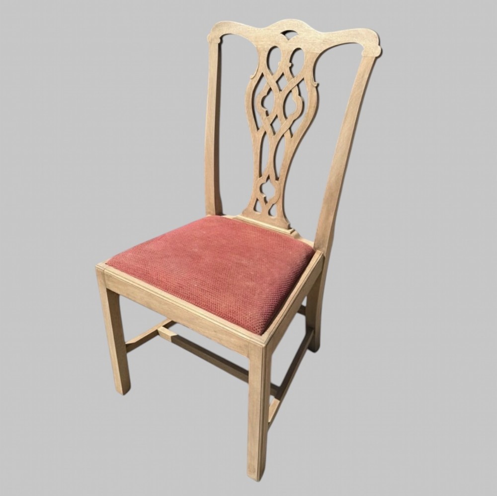 A set of eight bleached mahogany Georgian dining chairs featuring pierced fretwork back splats, straight square legs, and red fabric upholstered seats. View IV