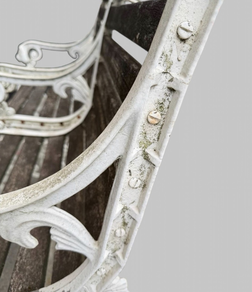 A pair of cast iron garden armchairs featuring white painted frames with lion mask armrest terminals and weathered timber slats. View IX