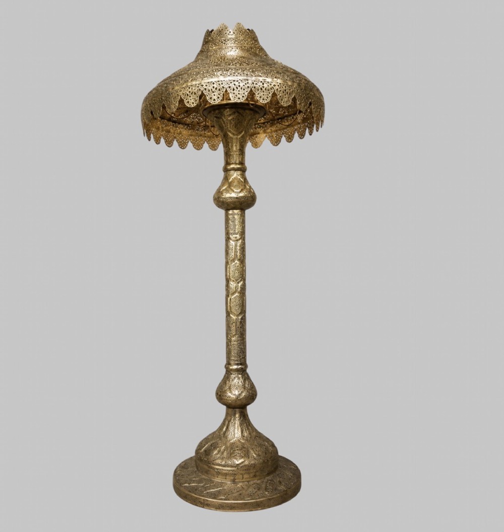 A tall Middle Eastern style brass floor lamp with an intricate pierced shade, decorative central column, and a wide flared base. View II