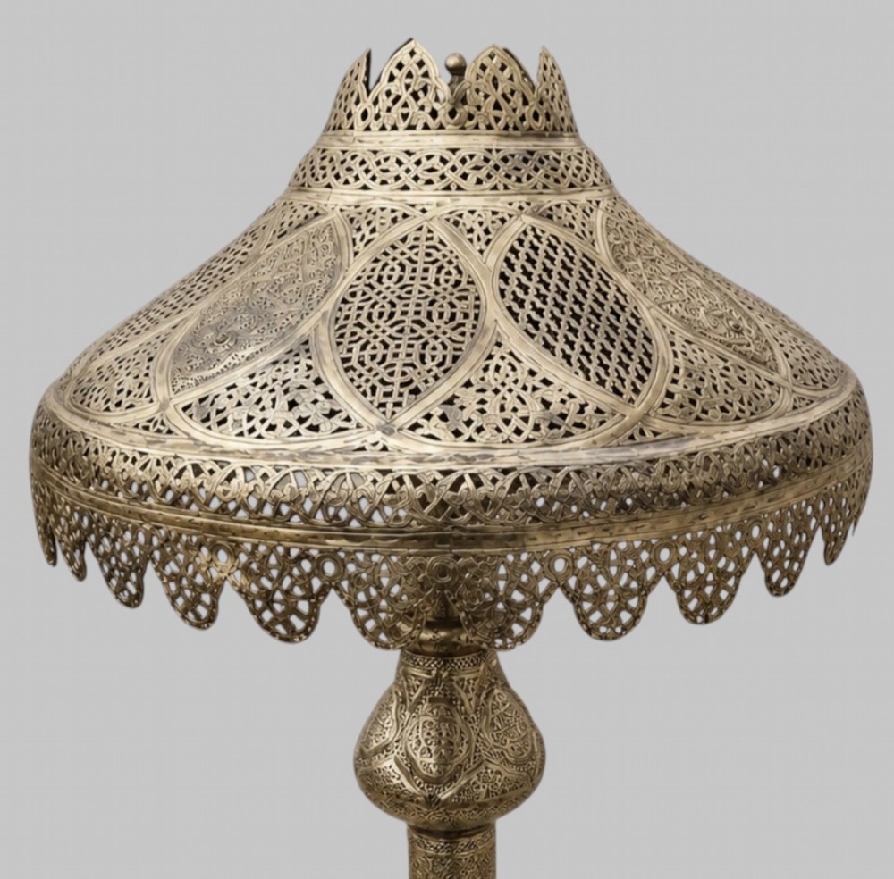 A tall Middle Eastern style brass floor lamp with an intricate pierced shade, decorative central column, and a wide flared base. View III