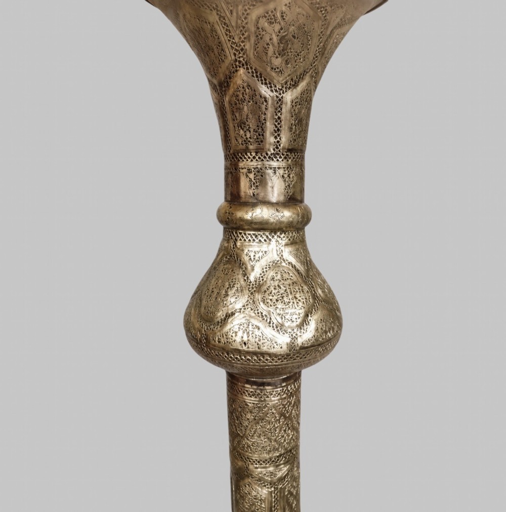 A tall Middle Eastern style brass floor lamp with an intricate pierced shade, decorative central column, and a wide flared base. View IV
