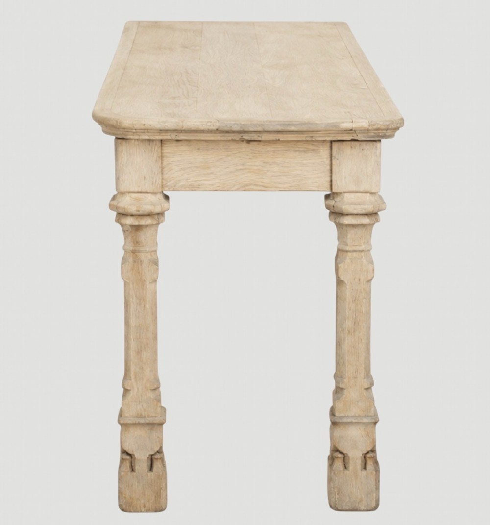 An early nineteenth-century bleached oak hall table featuring carved column supports and a plain rectangular top. View III
