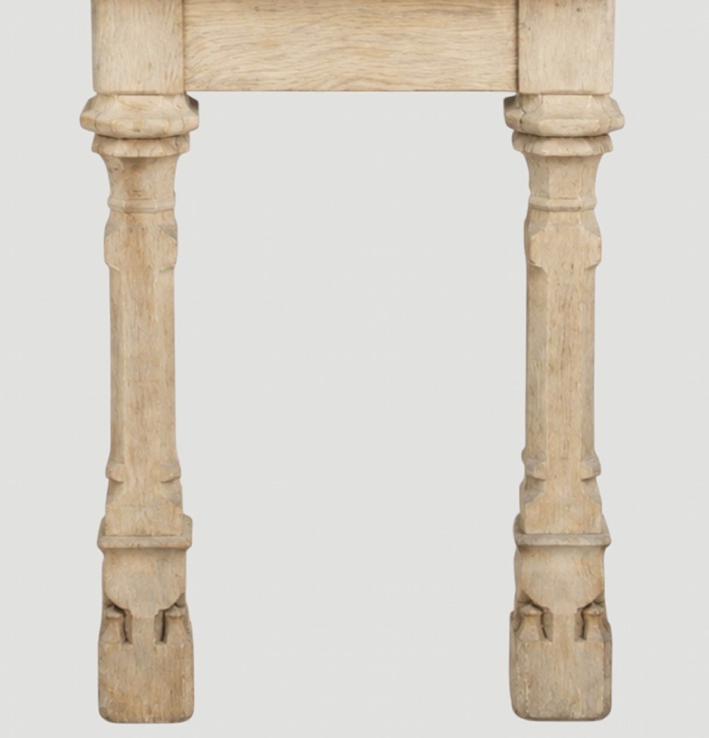 An early nineteenth-century bleached oak hall table featuring carved column supports and a plain rectangular top. View VI