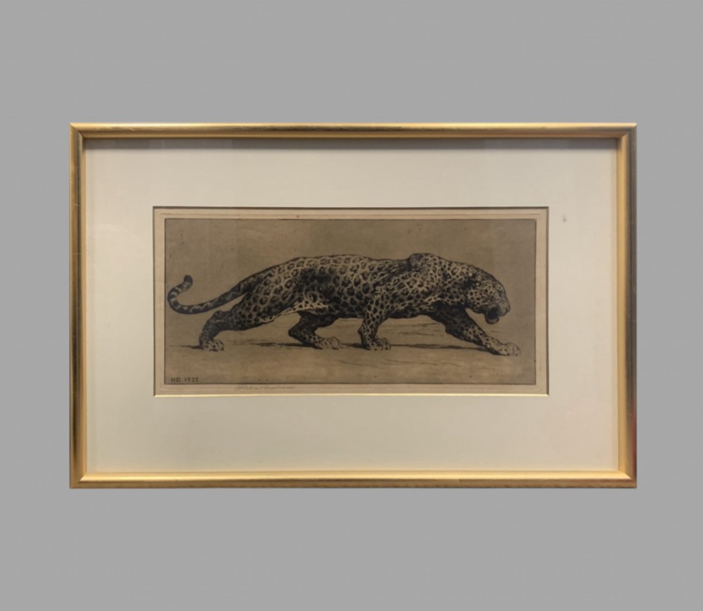 A framed monochrome sepia etching depicting a prowling leopard, signed and dated HD 1922 in the plate, set within a cream mount and gilt frame.