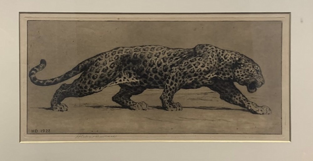 A framed monochrome sepia etching depicting a prowling leopard, signed and dated HD 1922 in the plate, set within a cream mount and gilt frame. View II