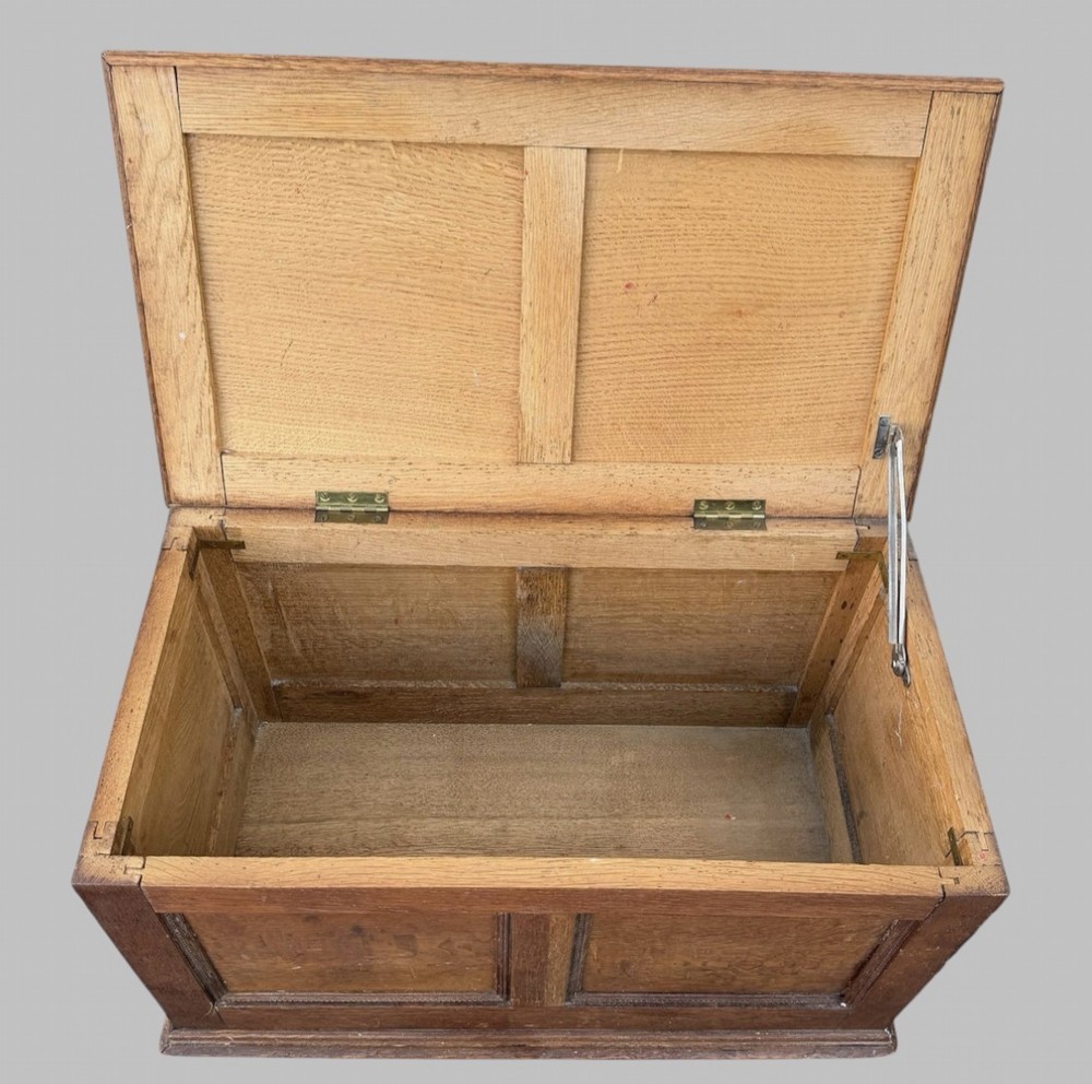 A solid oak Edwardian blanket chest featuring twin recessed front panels with carved beaded trim and a matching hinged lid. View II