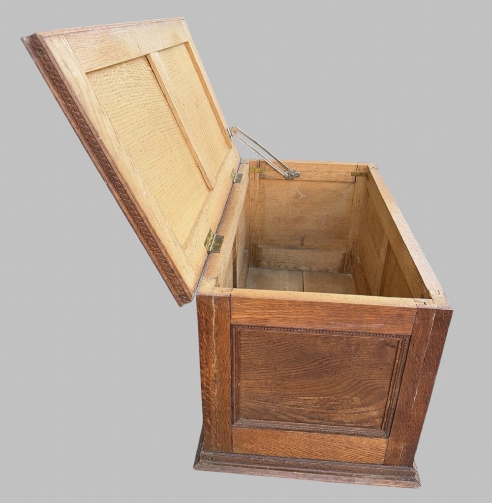 A solid oak Edwardian blanket chest featuring twin recessed front panels with carved beaded trim and a matching hinged lid. View III