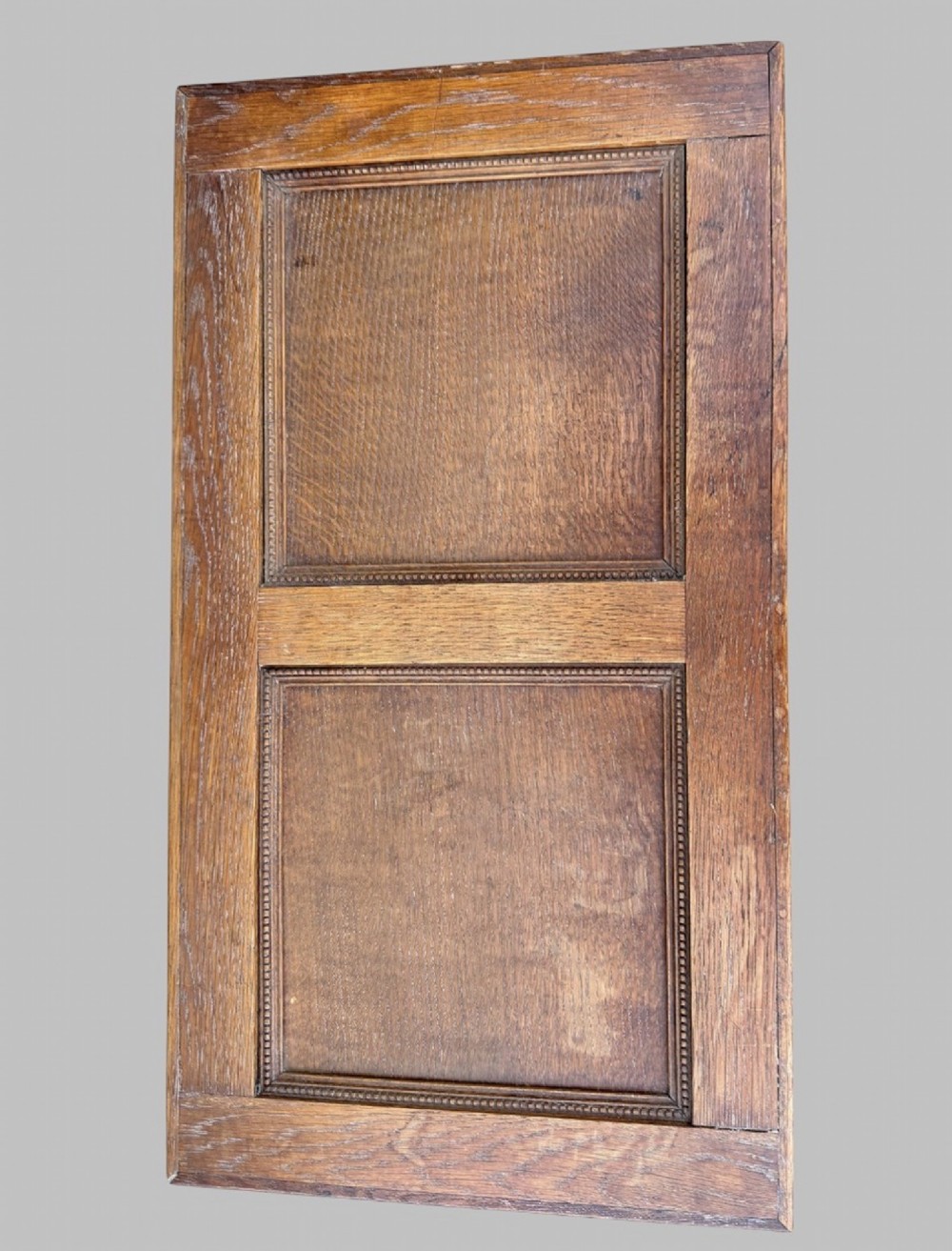 A solid oak Edwardian blanket chest featuring twin recessed front panels with carved beaded trim and a matching hinged lid. View VI