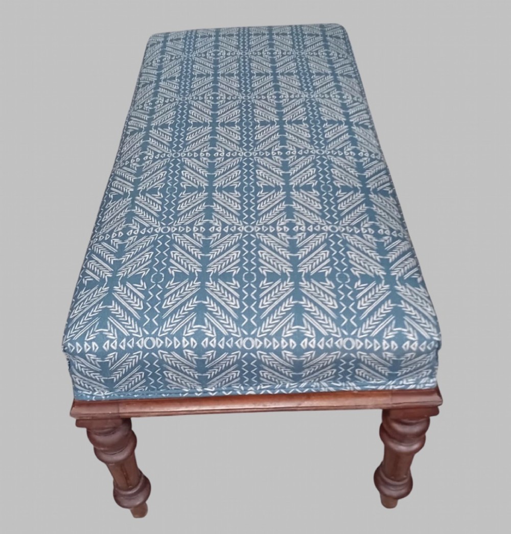A rectangular late Victorian walnut window seat with turned wooden legs and a blue patterned upholstered cushion. View IV