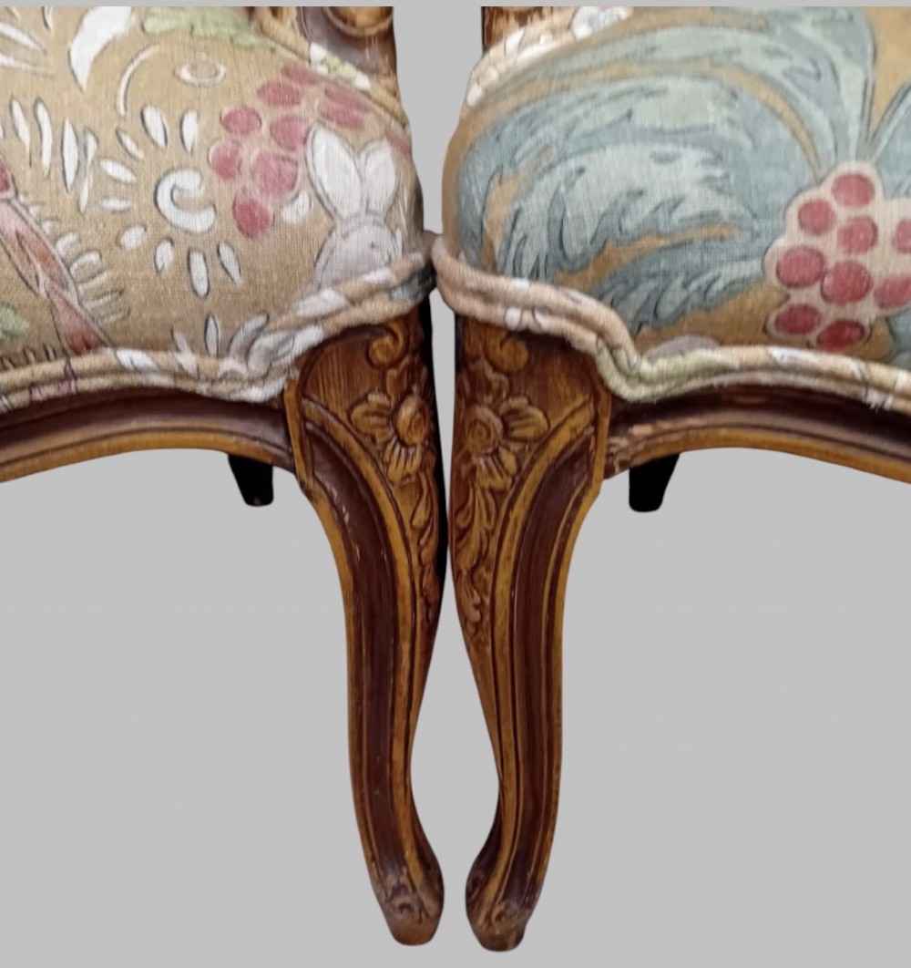 A pair of Neo-Rococo open armchairs featuring carved wooden frames, cabriole legs, and botanical tapestry upholstery. View IV